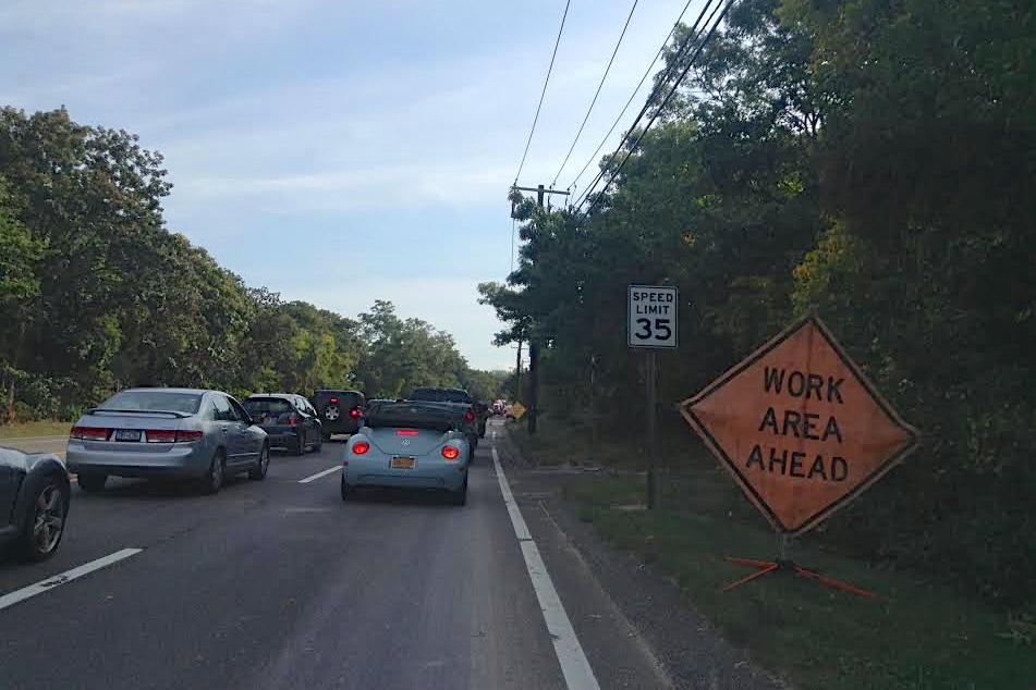 Traffic on County Road 39 Tuesday morning as tree trimmers cut back branches from power lines.