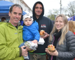 Greg Darvin holding Aleksei eating lobster rolls withJason Charrun and Tanya Pacheco