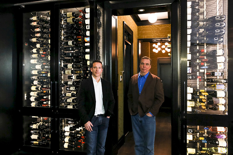 Joseph & Curtis founders Joe Kline and Curt Dahl in front of a fancy wine cellar