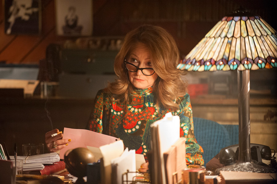 Melissa Leo as Goldie sitting at a desk in I'm Dying Up Here Season 2