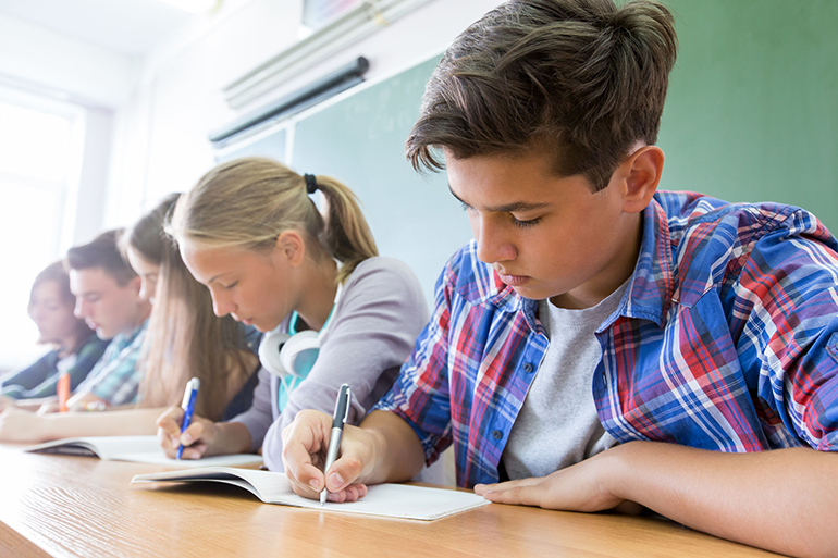 Group of students takes the test in class, Photo: Yanlev/123RF