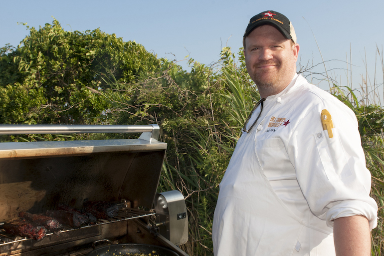 Ash Fulk of Hill Country BBQ tending a grill full of tri-tip