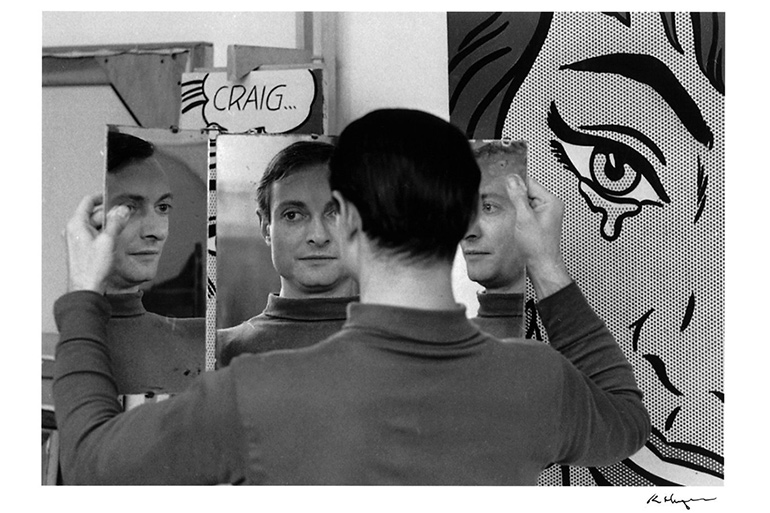 Roy Lichtenstein in front of his paintings Craig… (1964) and Happy Tears (1964) in his West 26th Street studio, NY, 1964. Art: © Estate of Roy Lichtenstein; Photograph: © Ken Heyman. Courtesy The Roy Lichtenstein Foundation