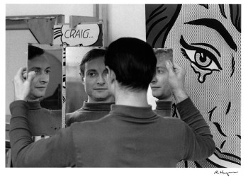 Roy Lichtenstein in front of his paintings Craig… (1964) and Happy Tears (1964) in his West 26th Street studio, NY, 1964. Art: © Estate of Roy Lichtenstein; Photograph: © Ken Heyman. Courtesy The Roy Lichtenstein Foundation