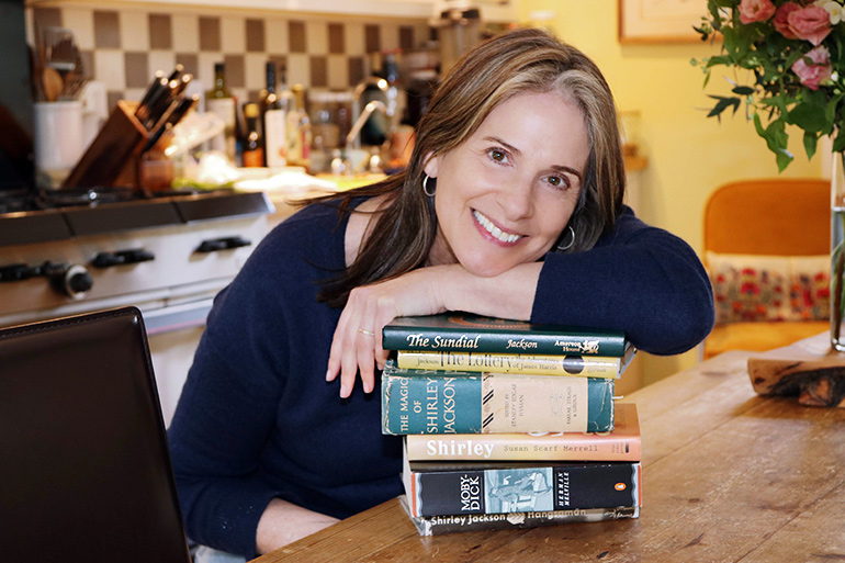Susan Merrell at home with her with books in Sag Harbor