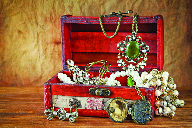 a collection of vintage jewelry in antique wooden jewelry box