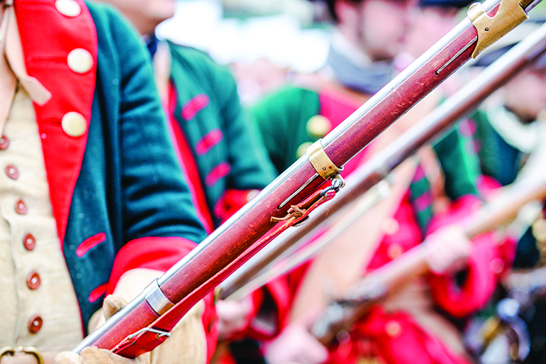 Revolutionary War building musketeers with guns. focus on the gun