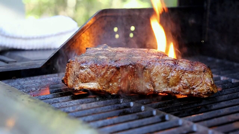 New York Prime Beef steak on the grill