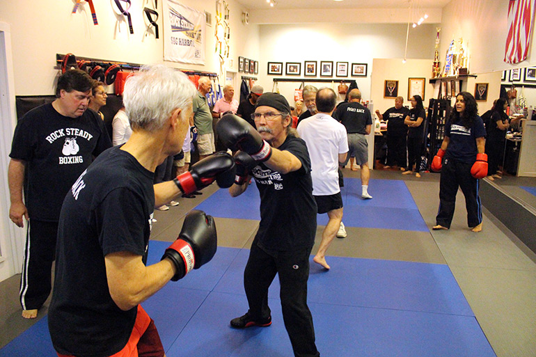 Michael Green (left) helps guide a sparring session