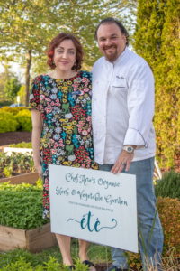 Dan's Hamptons Media Senior Editor Stacy Dermont with Bistro ete' Chef Arie stand in the organic herb & vegetable garden outside the doors of the restaurant
