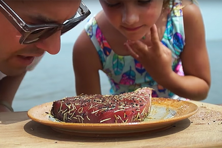 Cooking with Kyler father and daughter close up smelling Seared Tuna