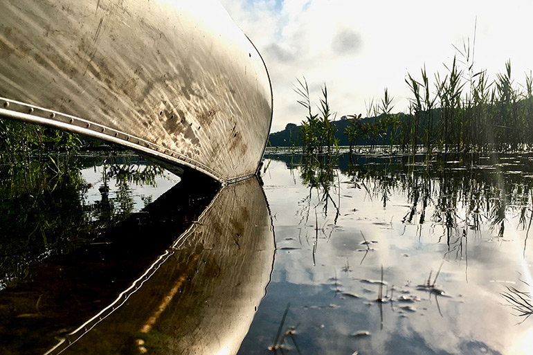 Canoe reflected on water by Joe Pallister (DesigningJoe)