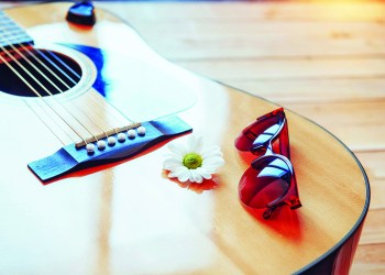 74624078 - detail of classic guitar with shallow depth of field.