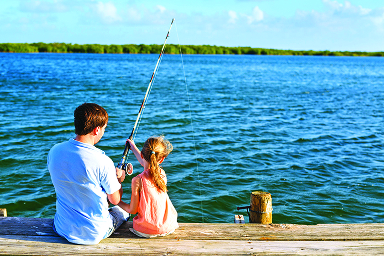 80042215 - family father and daughter fishing together from wooden jetty