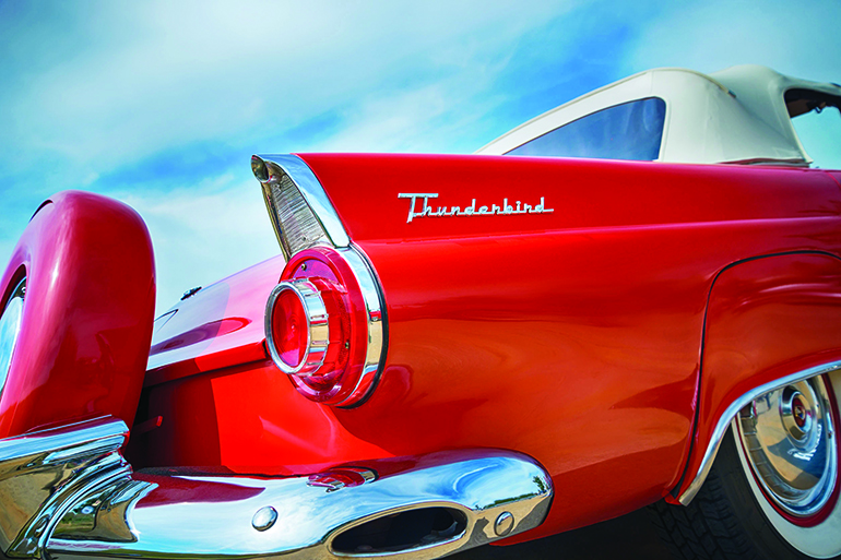 47763697 - westlake, texas - october 17, 2015: tail fin and taillight details of a red 1956 ford thunderbird convertible classic car.