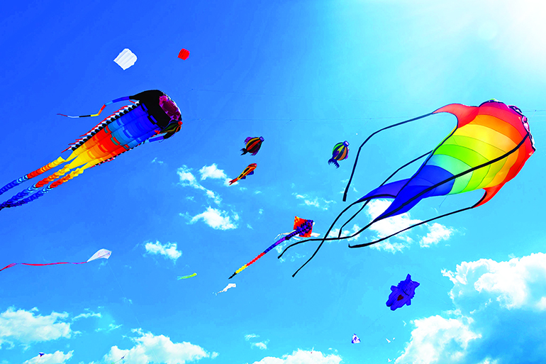43612941 - various kites flying on the blue sky in the kite festival