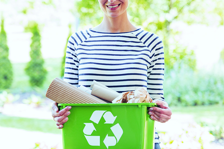 Woke woman separated paper from other waste to green container to save natural resources, Hamptons recycling