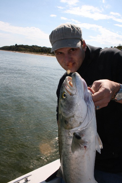 Oliver Peterson on boat holding nice bluefish