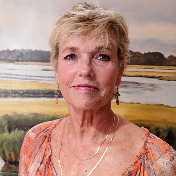 Eileen Dawn Skretch in front of a painting