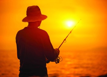 46656893 - fisherman silhouette at sunset near the sea with a fishing rod