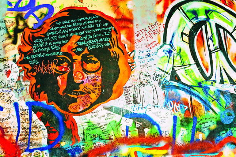 51412513 - prague, czech republic - october 10, 2014: famous place in prague - the john lennon wall. wall is filled with john lennon inspired graffiti and lyrics from beatles songs