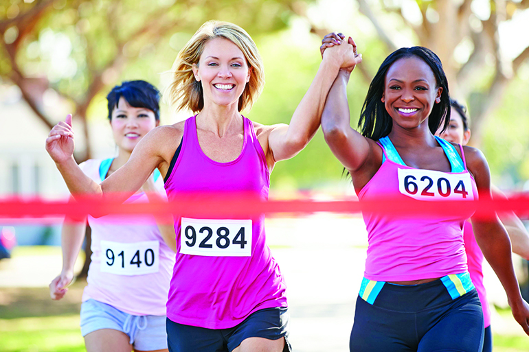 24489927 - two female runners finishing race together