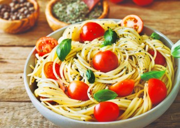 italian cuisine. pasta with olive oil, garlic, basil and tomatoes. spaghetti with tomatoes