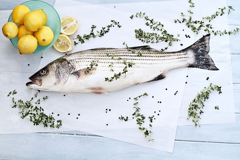 Whole striped bass with lemons and herbs