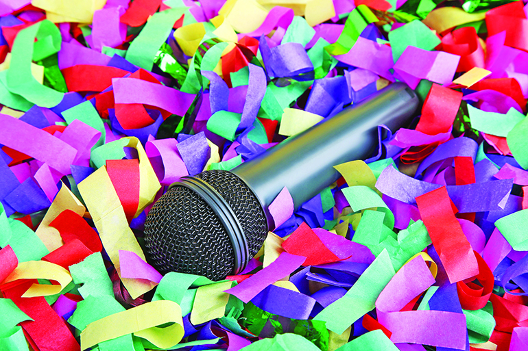 Black microphone on colourful confetti