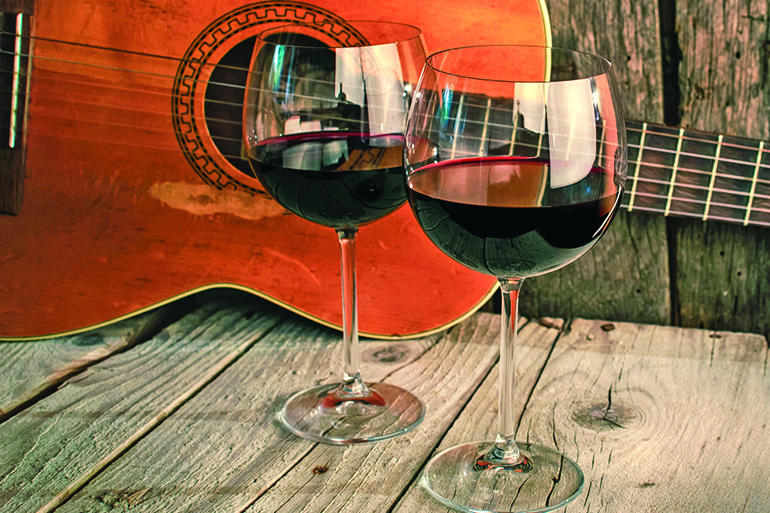 30212246 - guitar and wine on a wooden table romantic dinner background