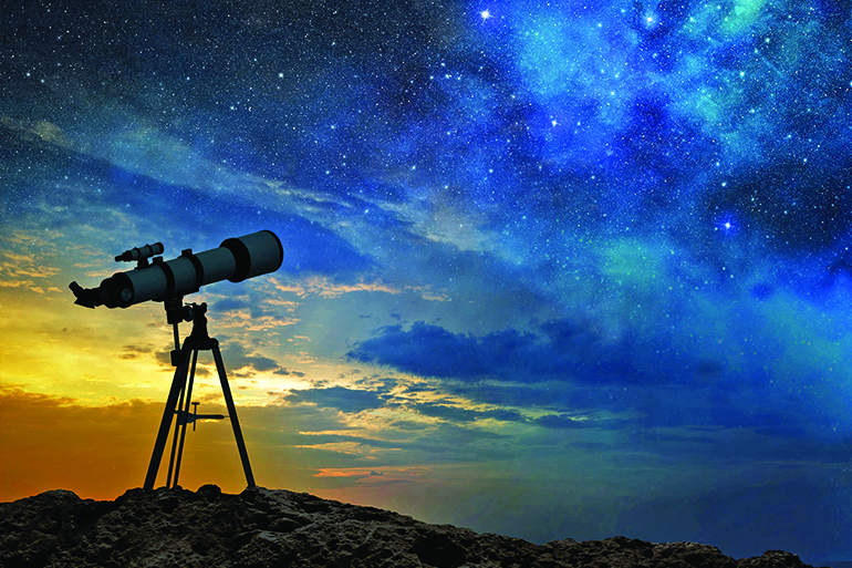 milky way at dawn and silhouette of a telescope