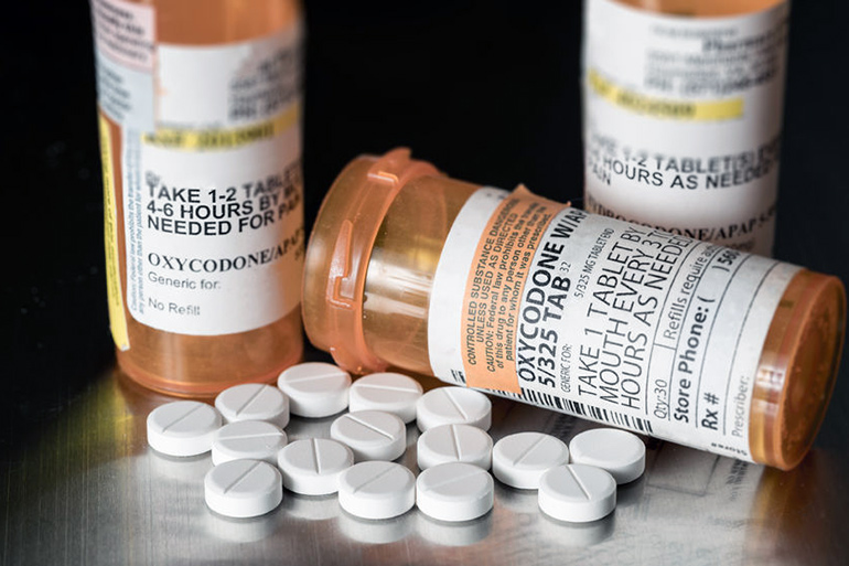 Opioid prescription pills and pill bottles: oxycodone, hydrocodone