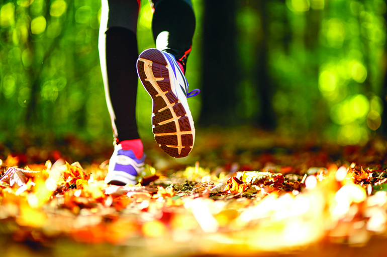 Woman exercise walking outdoors, shoes closeup