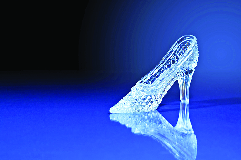 Nice glass slipper on dark blue background with free space for text