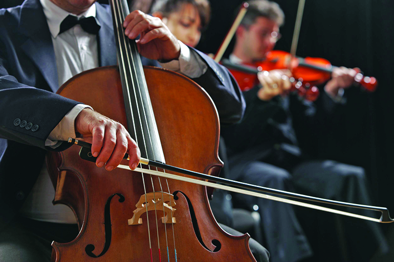 symphony concert, a man playing the cello, hand close up