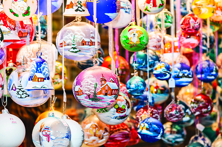 Colorful Christmas bells hanging in a traditional Christmas market stall.
