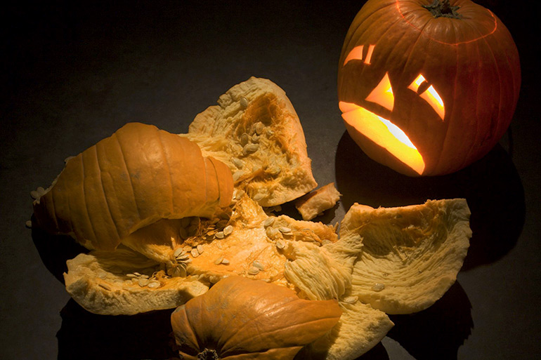Smashed pumpkin and frowning jack-o-lantern