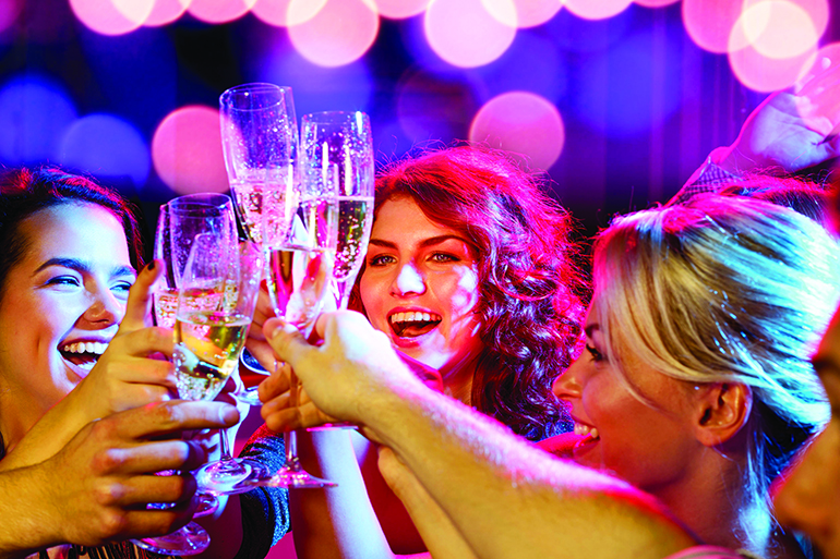 party, holidays, celebration, nightlife and people concept - smiling friends with glasses of champagne in club smiling friends with glasses of champagne in club