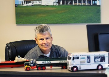 Twin Forks Moving & Storage owner Christopher Denon with his prized Hess Toy Trucks