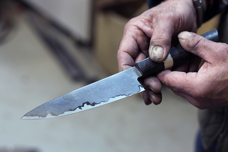 Dereyk Patterson displays one of his DP Knives damascus blades