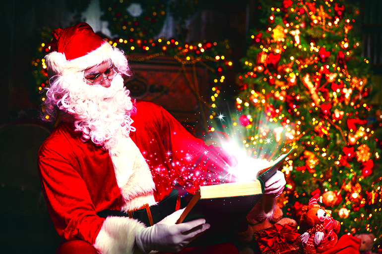 Santa Claus at Christmas with glowing magical book