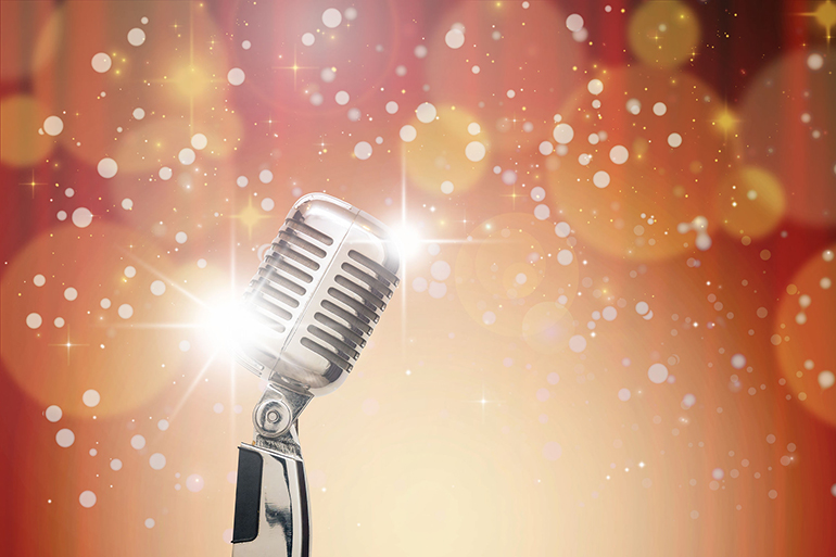 Retro microphone over the Abstract photo of Christmas and blurred background, vintage musical concept