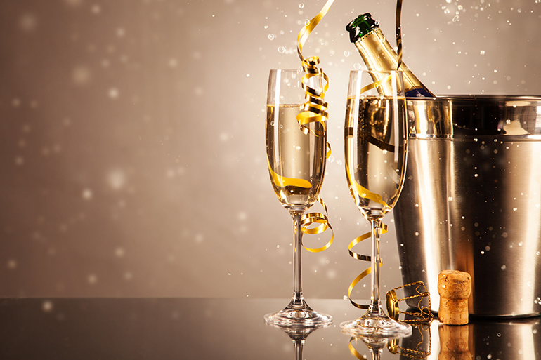 glasses of champagne with ribbons and bubbles around. concept of celebration