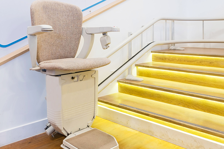 Automatic stair lift on staircase for elderly people and disabled persons