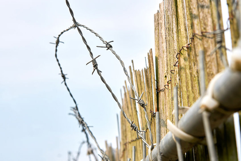 Barbed wire prison fence