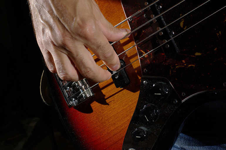 man playing an bass guitar