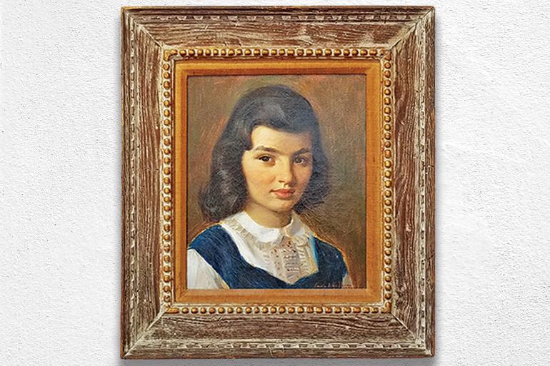 Framed painted portrait of young Jackie Bouvier, future First Lady Jackie Kennedy hanging on white wall