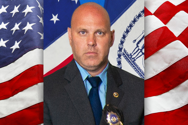 NYPD Detective Brian Simonsen on American flag background