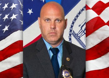 NYPD Detective Brian Simonsen on American flag background