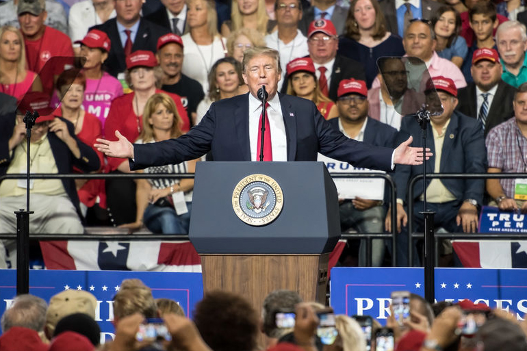 Donald Trump spreadds his arms out in front of a huge crowd at his Tampa, Florida rally on July 31, 2018
